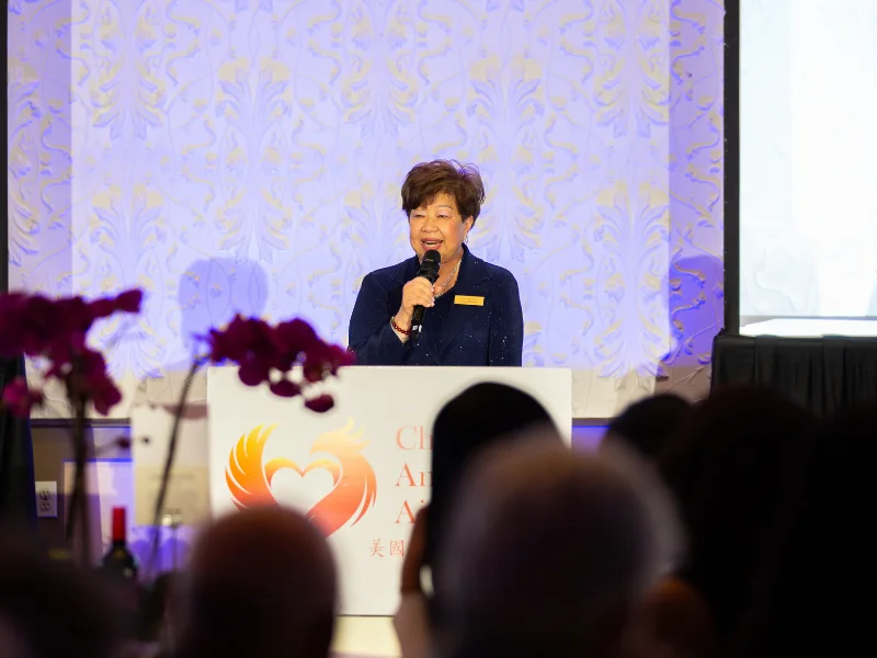 President Lina Fang speaking at the podium during the Visionaries of Tomorrow 2026 Gala.