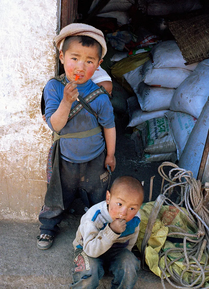 Two young children in a doorway, Liangshan Prefecture.