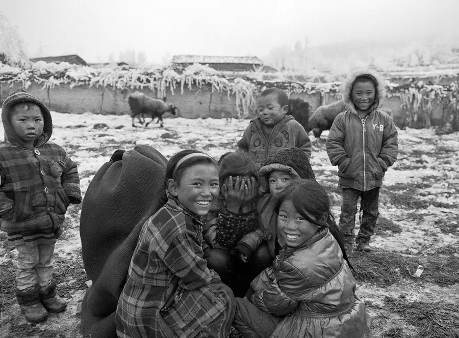 Children gathered together outdoors, Liangshan Prefecture.